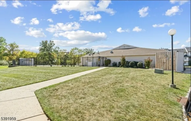 an aerial view of a house with a garden and lake view