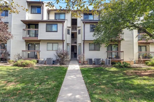 a bedroom with bed and a couch next to a window