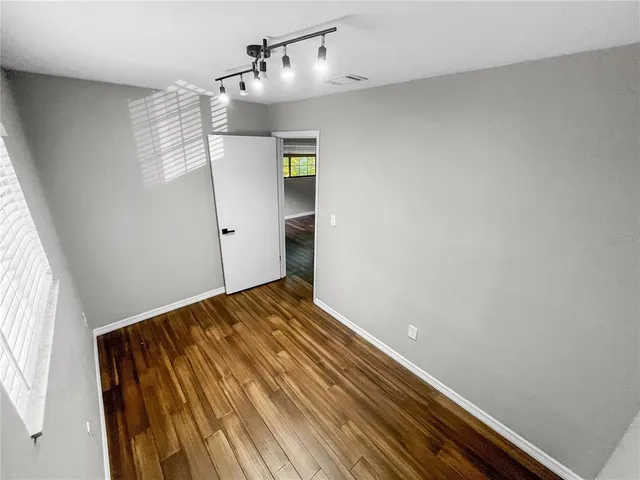 a view of a room with wooden floor