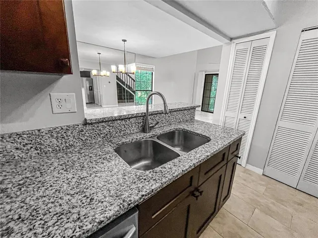 a kitchen with a sink and a refrigerator