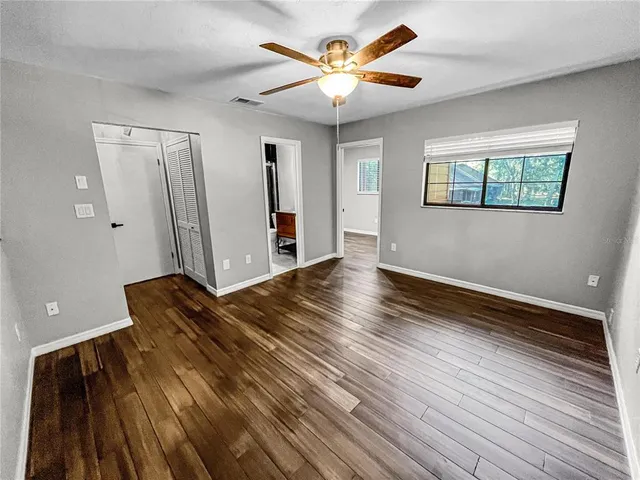 a view of workspace with wooden floor and ceiling fan