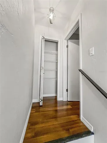 a view of room with hardwood floor and ceiling fan