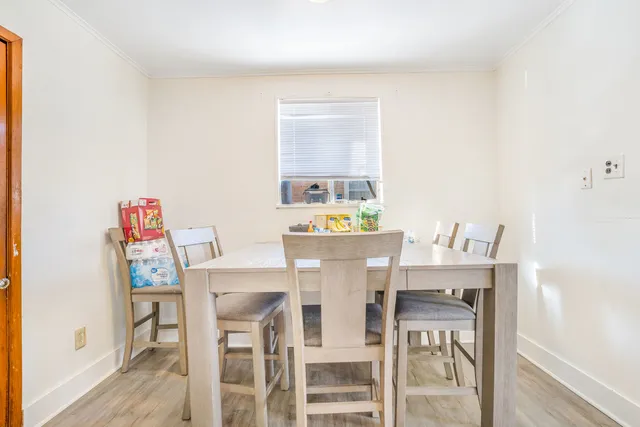 a dining room with furniture and window