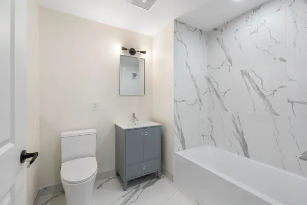 a bathroom with a toilet and a bathtub
