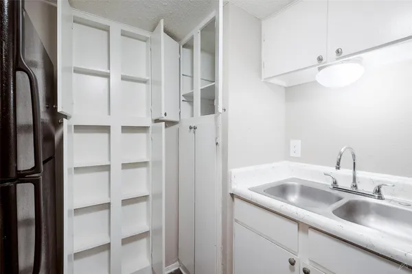 a kitchen with a sink stove and cabinets
