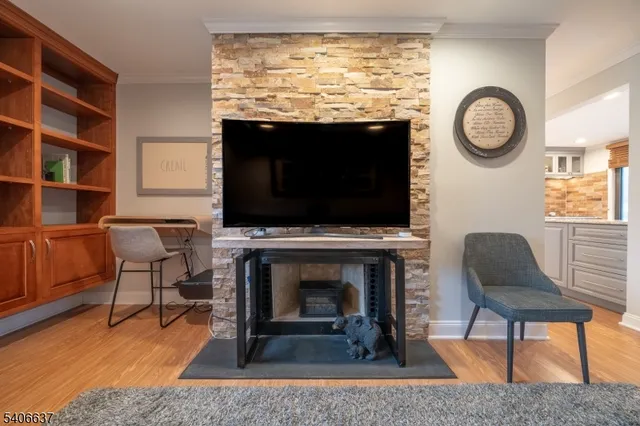 a living room with a flat screen tv and a fireplace
