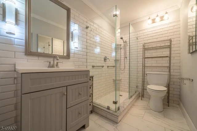 a bathroom with a shower toilet sink and mirror