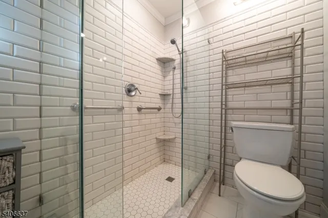 a bathroom with a toilet and shower