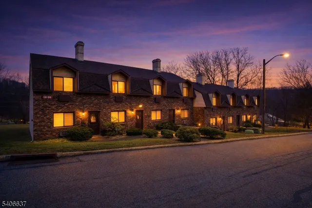 a front view of a building with a yard