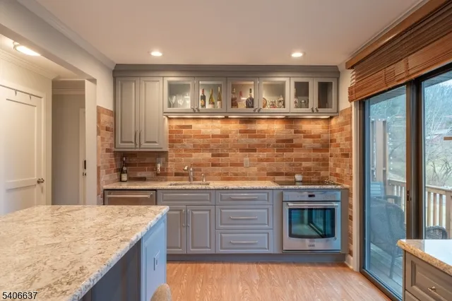 a kitchen with stainless steel appliances granite countertop a stove and cabinets