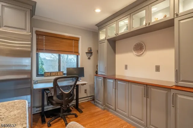 a view of a workspace with furniture and a window