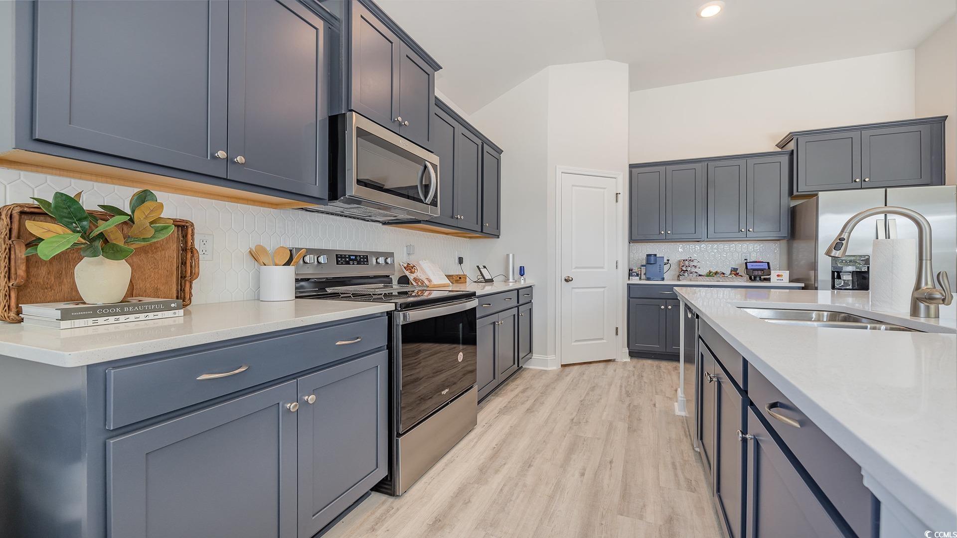 526 Haven View Way Murrells Inlet, SC 29576 - Photo 13 of 31 Kitchen with a breakfast bar, sink, light wood-typ
