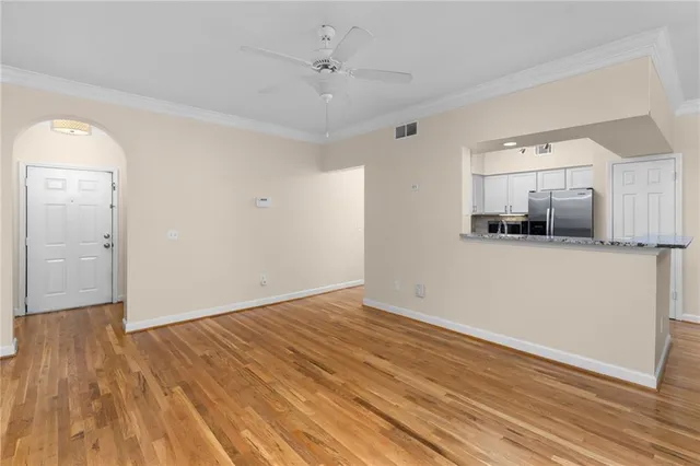 a kitchen with stainless steel appliances granite countertop a refrigerator and a stove top oven