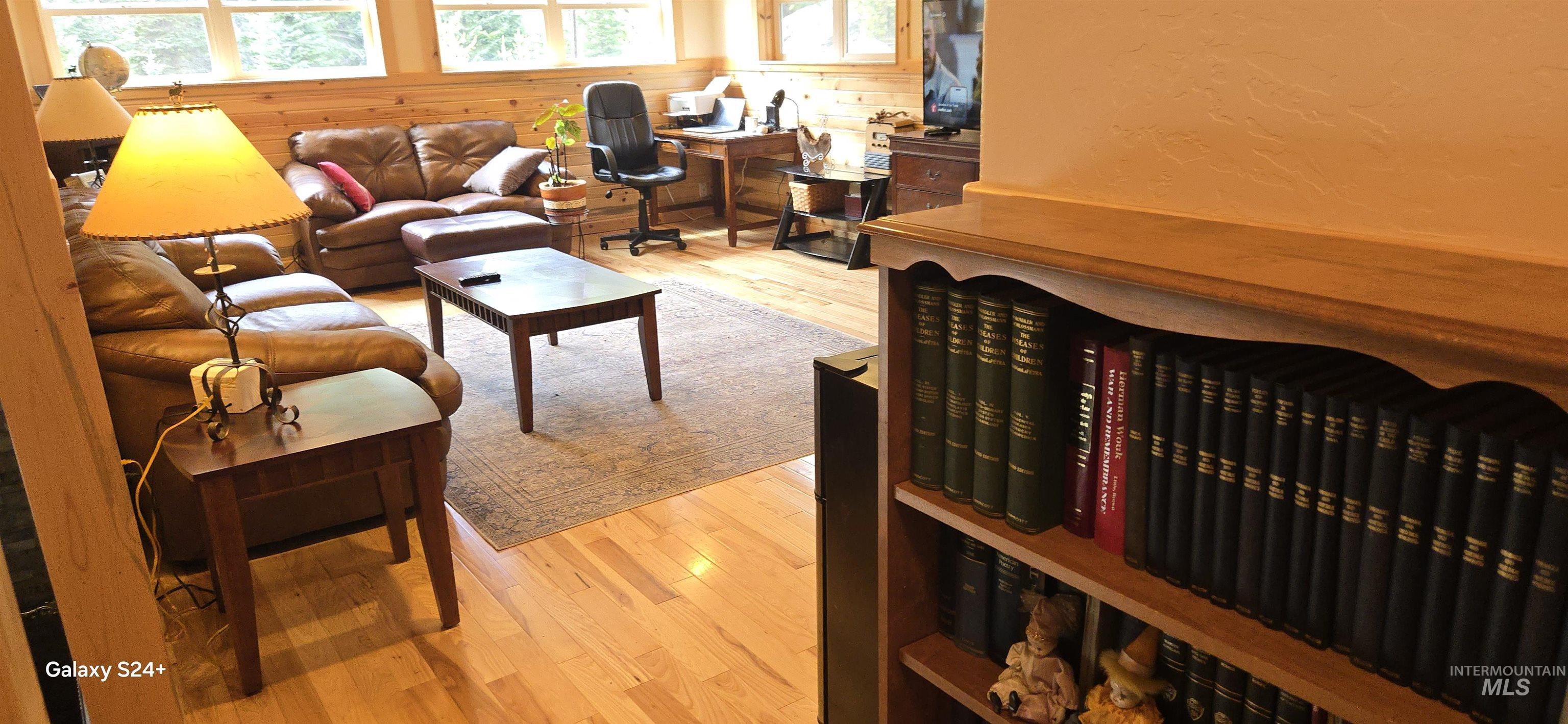 4250 American River Road Elk City, ID 83525 - Photo 11 of 28 Living area featuring light wood-style floors and a textured wall