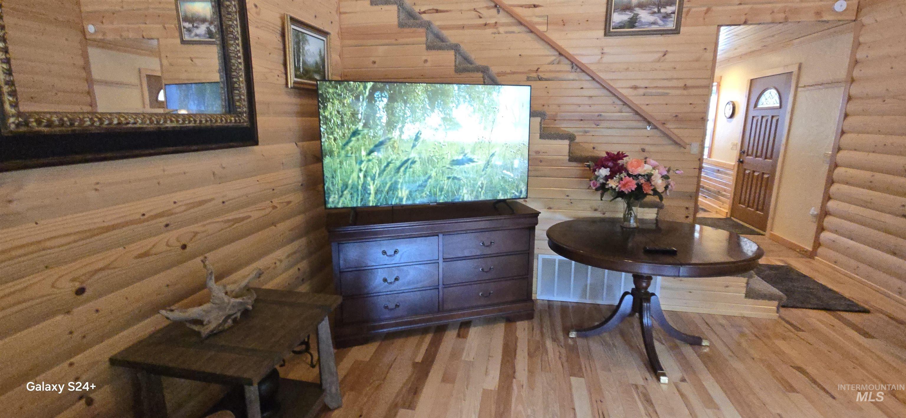 4250 American River Road Elk City, ID 83525 - Photo 13 of 28 Interior space featuring wood finished floors, log walls, and wooden walls