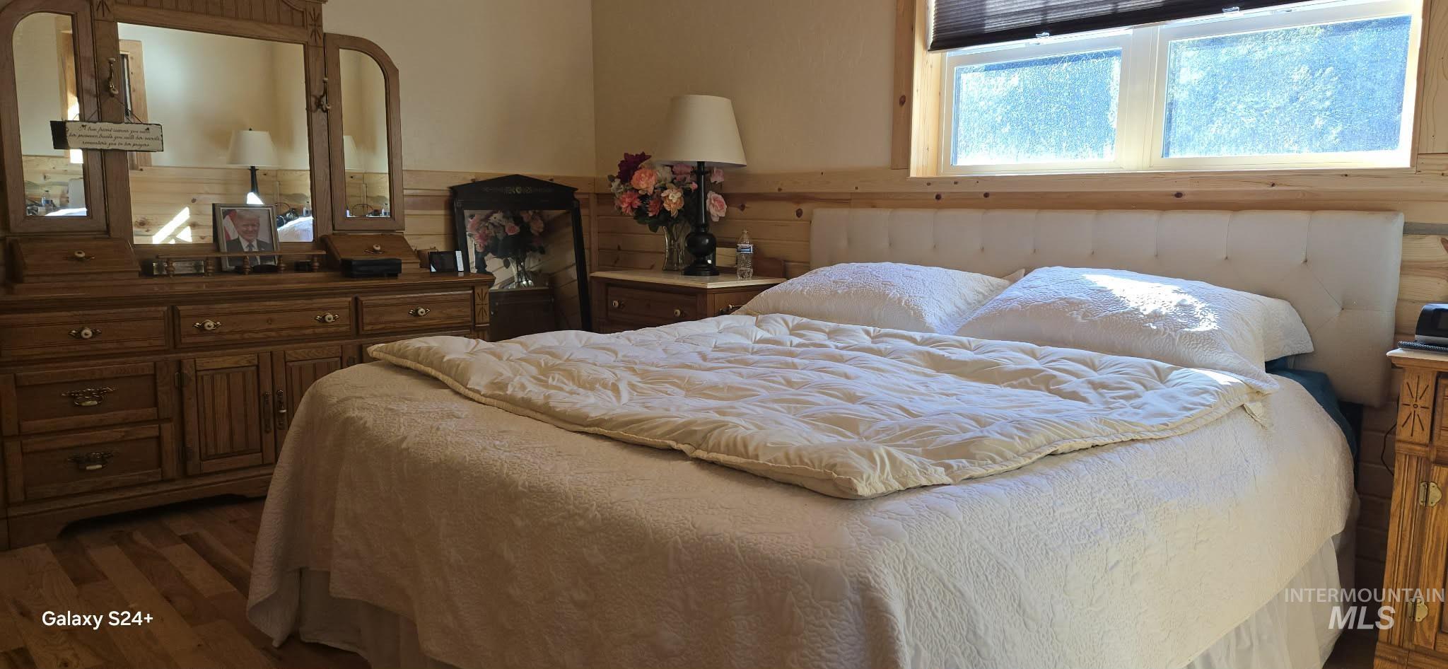 4250 American River Road Elk City, ID 83525 - Photo 22 of 28 Bedroom with dark wood-type flooring and wood walls