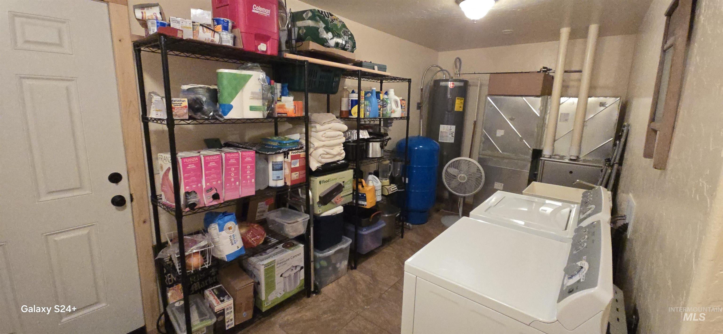 4250 American River Road Elk City, ID 83525 - Photo 24 of 28 Laundry room featuring electric water heater and separate washer and dryer