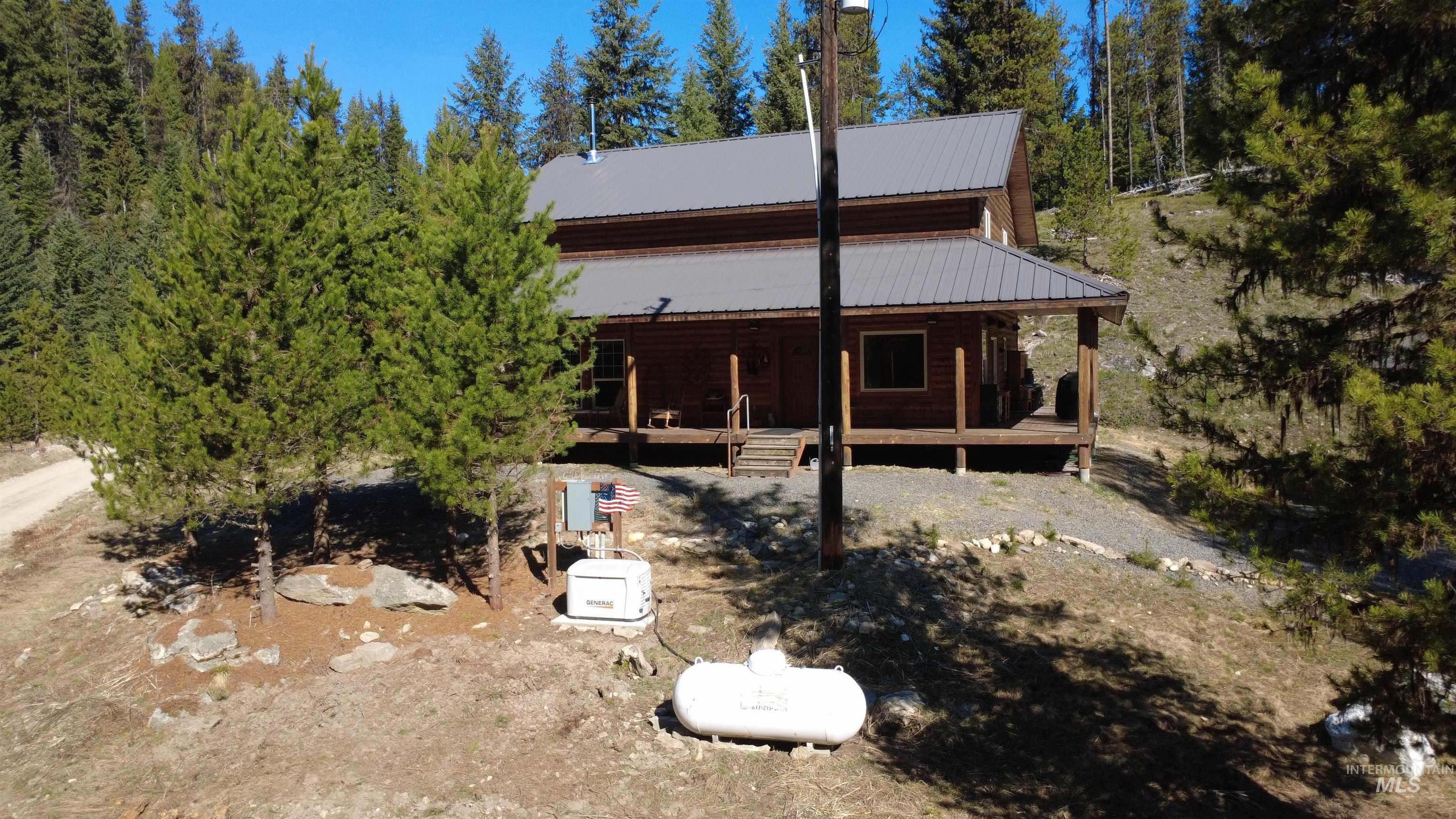 4250 American River Road Elk City, ID 83525 - Photo 35 of 46 Rear view of property featuring a metal roof