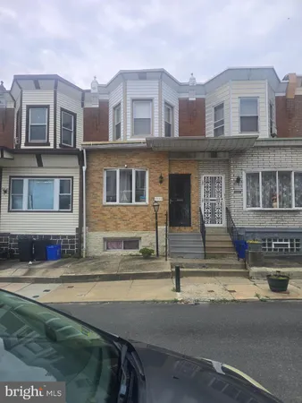 a front view of a residential apartment building with a yard