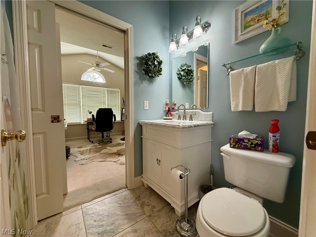 302 Wilcox Road Youngstown, OH 44515 - Photo 13 of 30 Bathroom featuring tile flooring, white vanity with stone countertop, and a built-in toilet