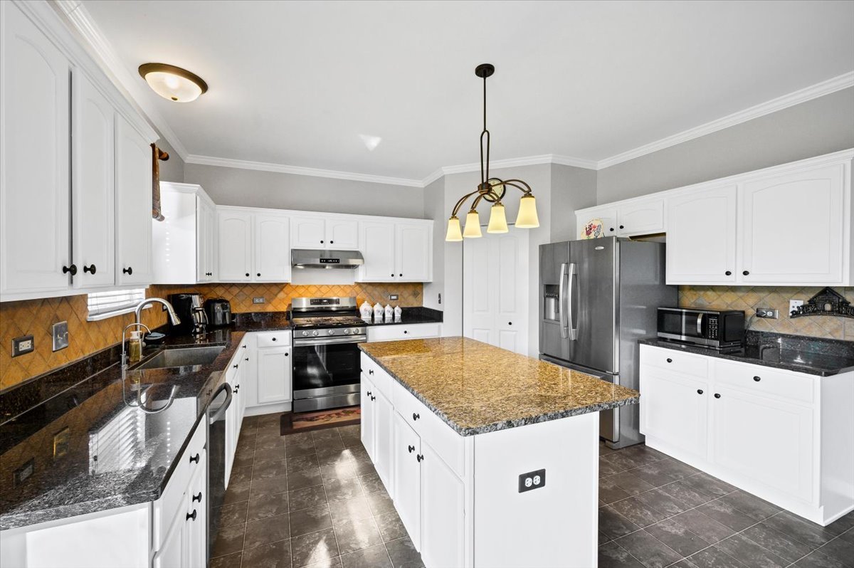 322 Zinnia Drive Romeoville, IL 60446 - Photo 2 of 42 a kitchen with stainless steel appliances granite countertop a sink a stove and a refrigerator
