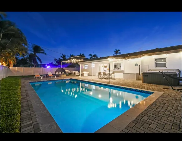 a view of a swimming pool with seating space