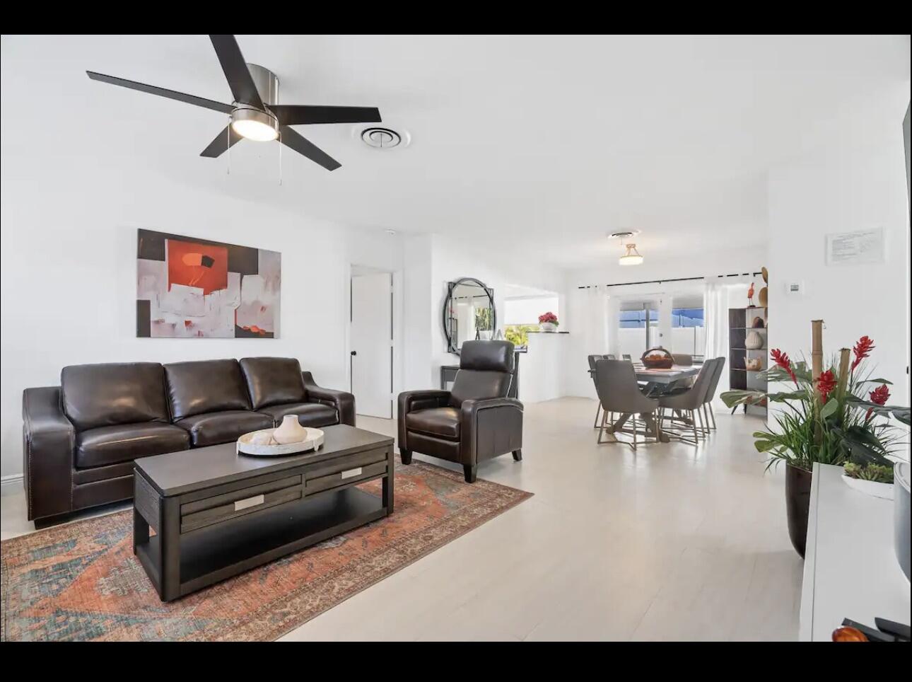 5040 Northeast 22nd Avenue Lighthouse Point, FL 33064 - Photo 11 of 32 a living room with furniture and a dining table