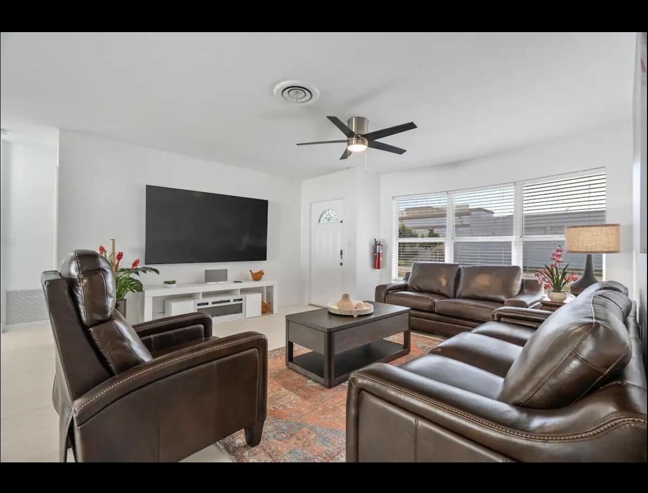 5040 Northeast 22nd Avenue Lighthouse Point, FL 33064 - Photo 12 of 32 a living room with furniture and a flat screen tv