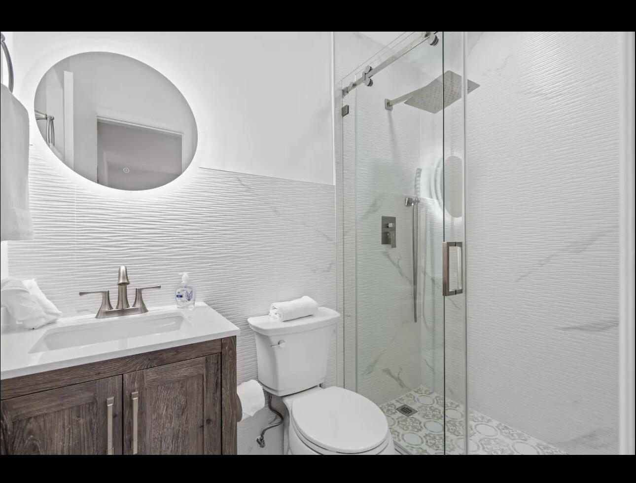 5040 Northeast 22nd Avenue Lighthouse Point, FL 33064 - Photo 18 of 32 a bathroom with a sink toilet and shower