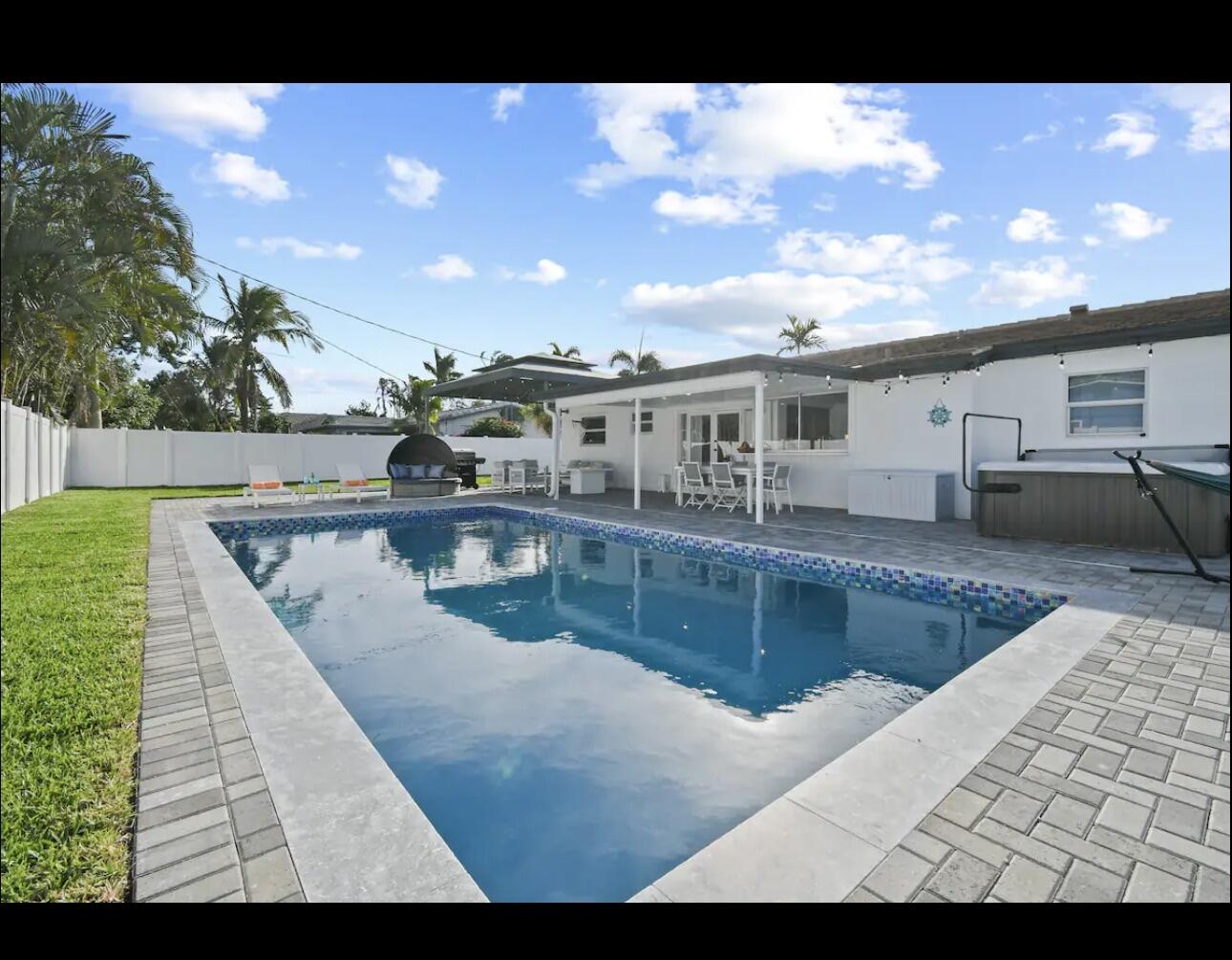 5040 Northeast 22nd Avenue Lighthouse Point, FL 33064 - Photo 2 of 32 a view of a house with swimming pool