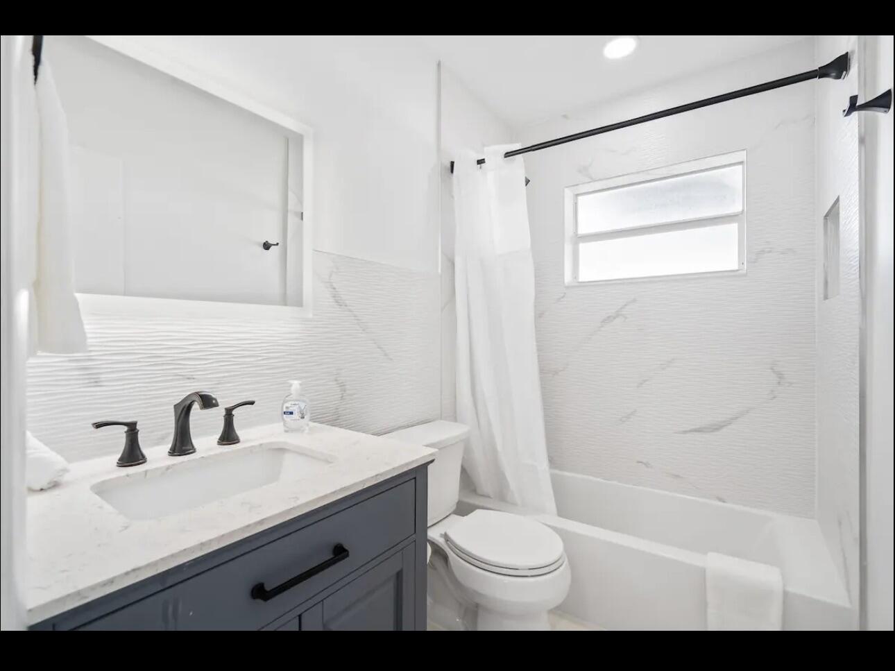 5040 Northeast 22nd Avenue Lighthouse Point, FL 33064 - Photo 21 of 32 a bathroom with a sink a toilet and shower