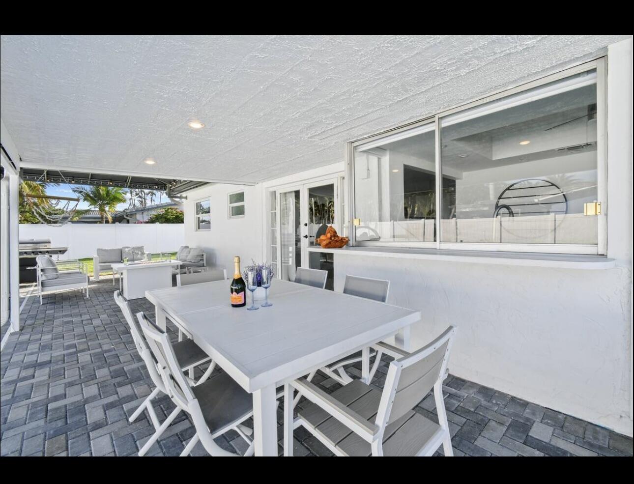 5040 Northeast 22nd Avenue Lighthouse Point, FL 33064 - Photo 25 of 32 a dining room with furniture and a large window