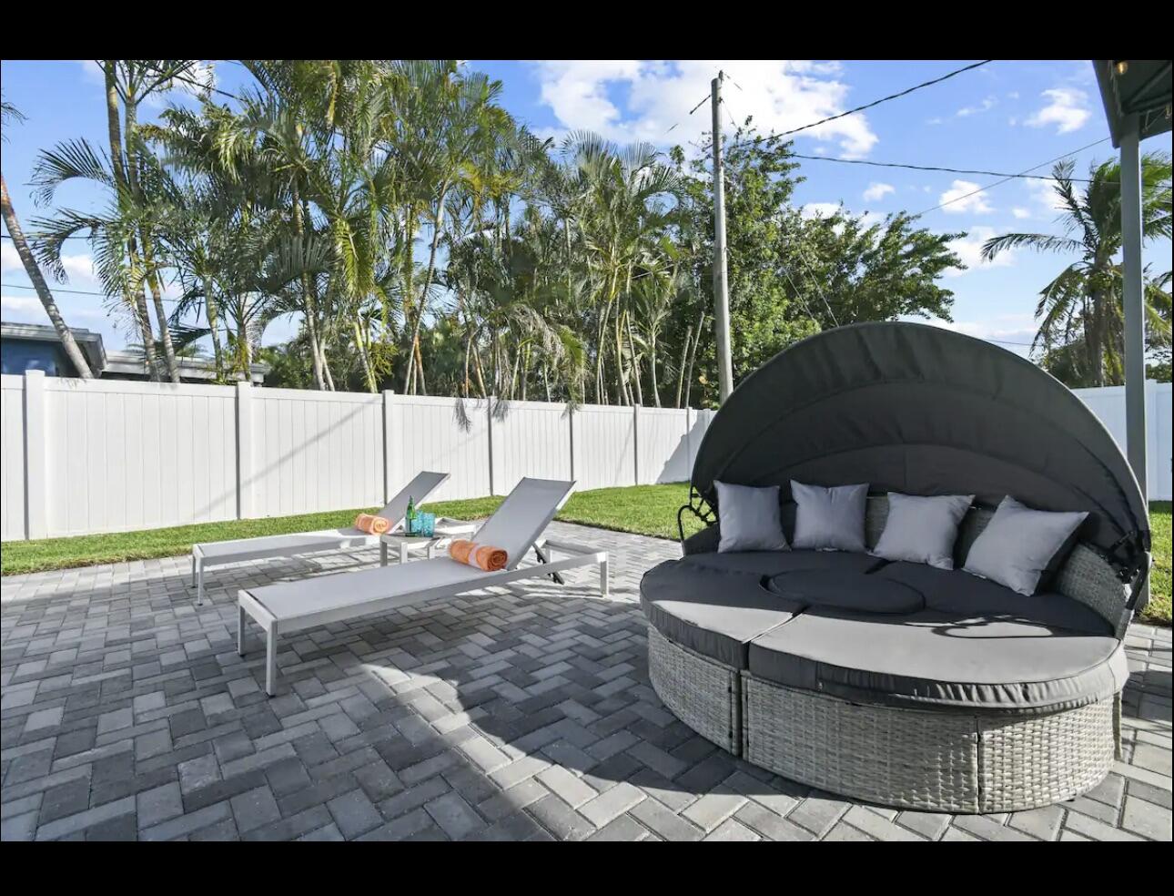 5040 Northeast 22nd Avenue Lighthouse Point, FL 33064 - Photo 26 of 32 a view of a backyard with couches and swimming pool