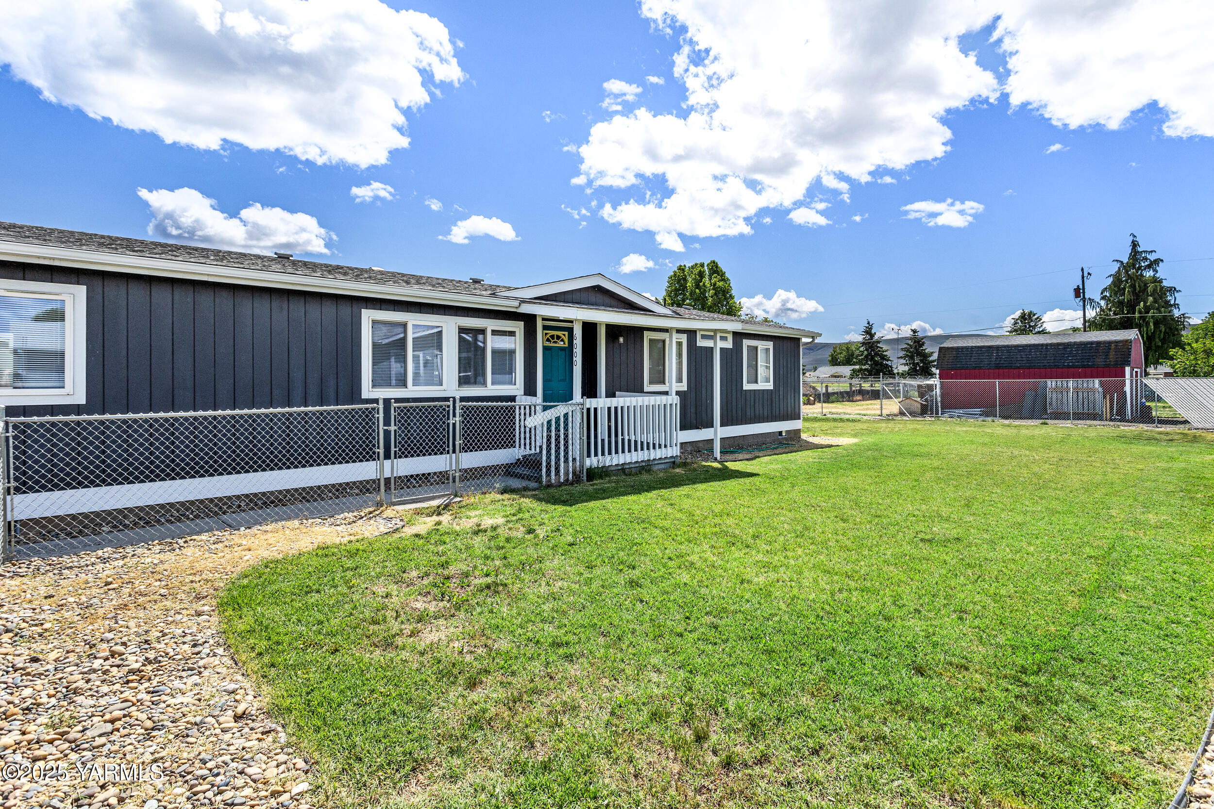 6000 Crestfields Road Yakima, WA 98903 - Photo 2 of 16 a view of a house with a backyard and a patio