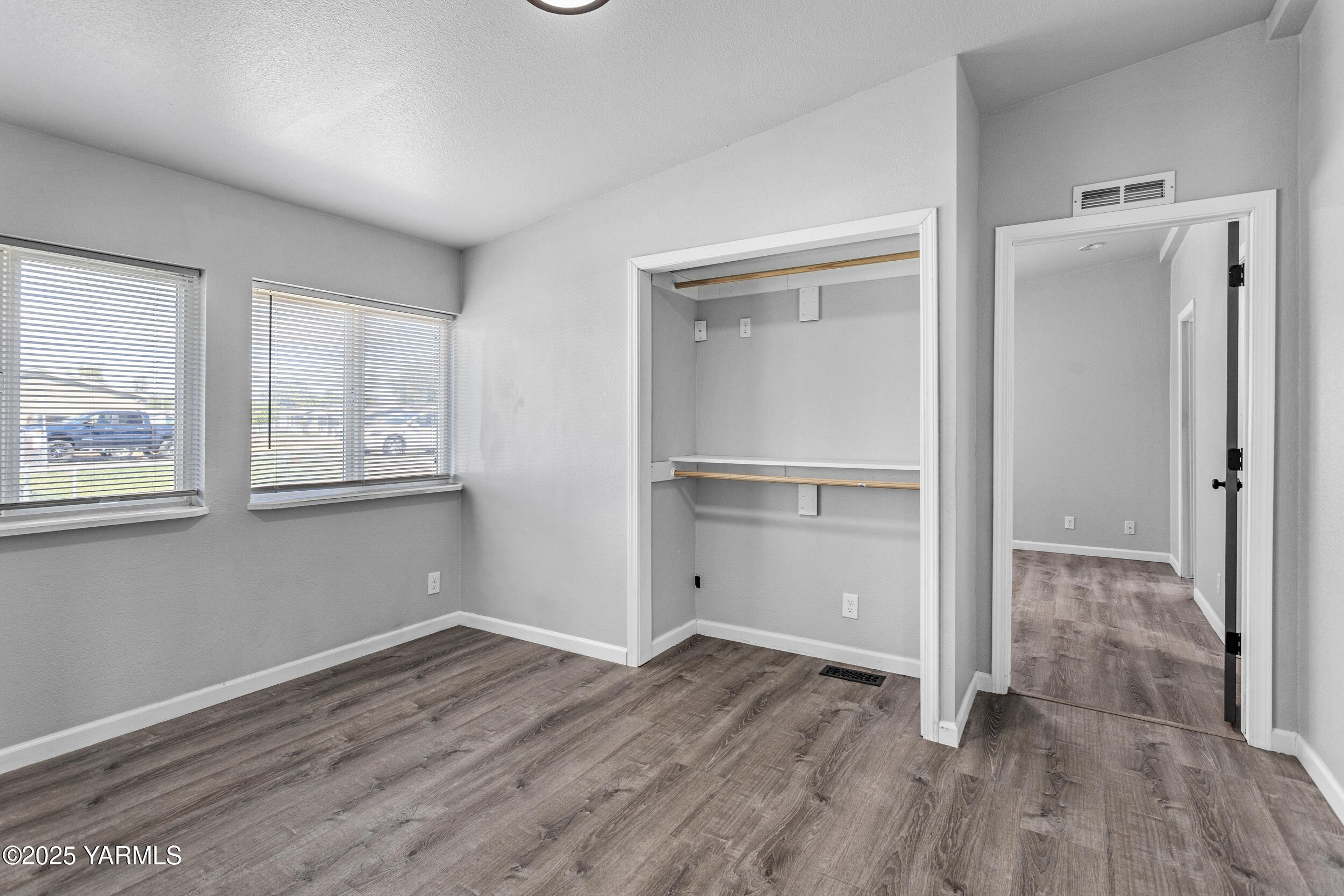 6000 Crestfields Road Yakima, WA 98903 - Photo 9 of 16 an empty room with wooden floor cabinet and windows