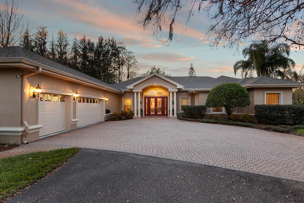 6229 Tower Road Land O' Lakes, FL 34638 - Photo 1 of 1 Front Elevation with Paver Driveway At Sunset