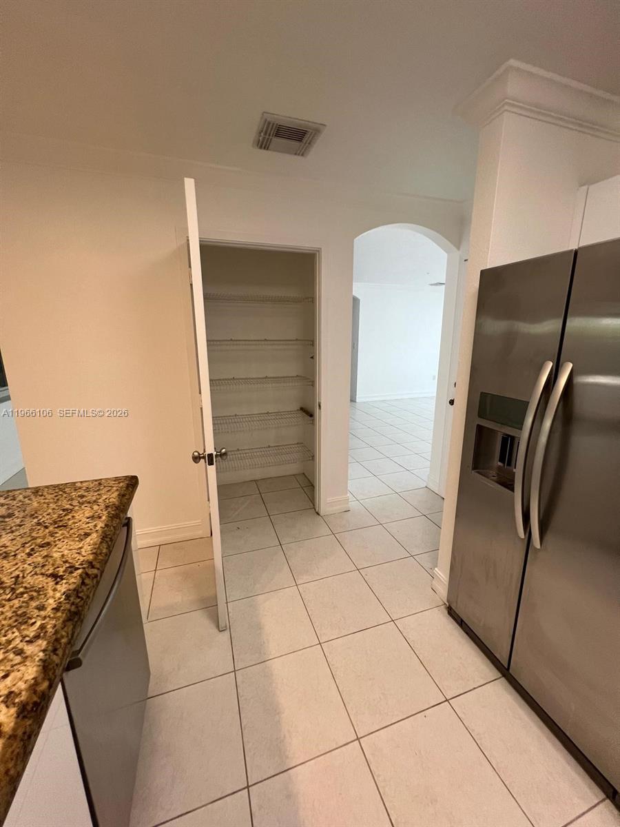 11320 Southwest 245th Street Homestead, FL 33032 - Photo 16 of 21 a kitchen with granite countertop a refrigerator and a stove