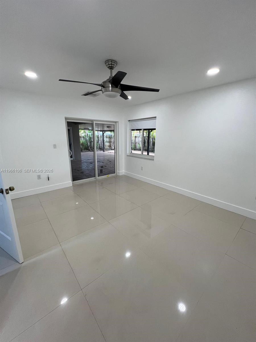 11320 Southwest 245th Street Homestead, FL 33032 - Photo 19 of 21 wooden floor in an empty room with a window