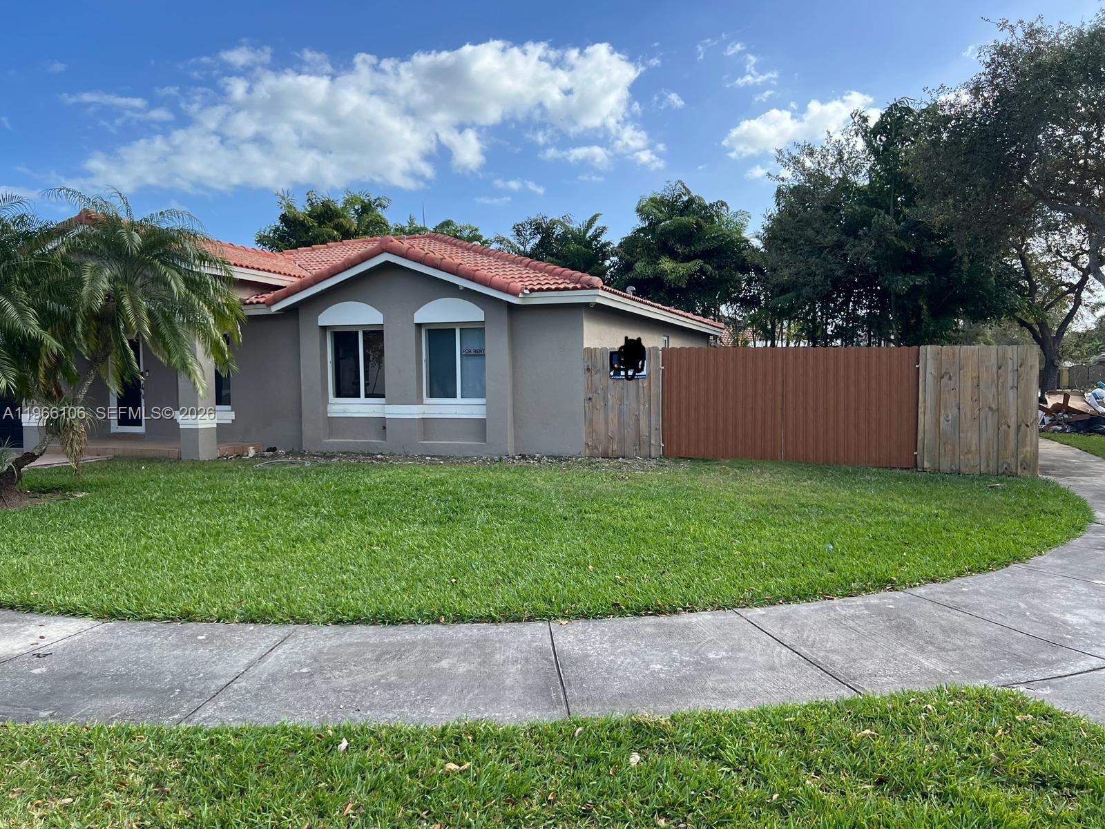 11320 Southwest 245th Street Homestead, FL 33032 - Photo 2 of 21 a front view of house with a garden