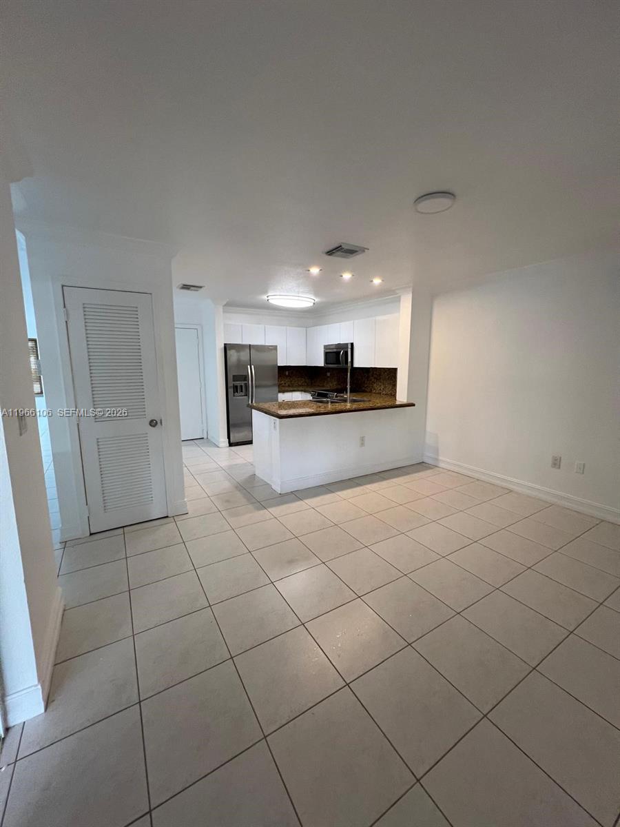 11320 Southwest 245th Street Homestead, FL 33032 - Photo 7 of 21 a large kitchen with stainless steel appliances a sink and cabinets