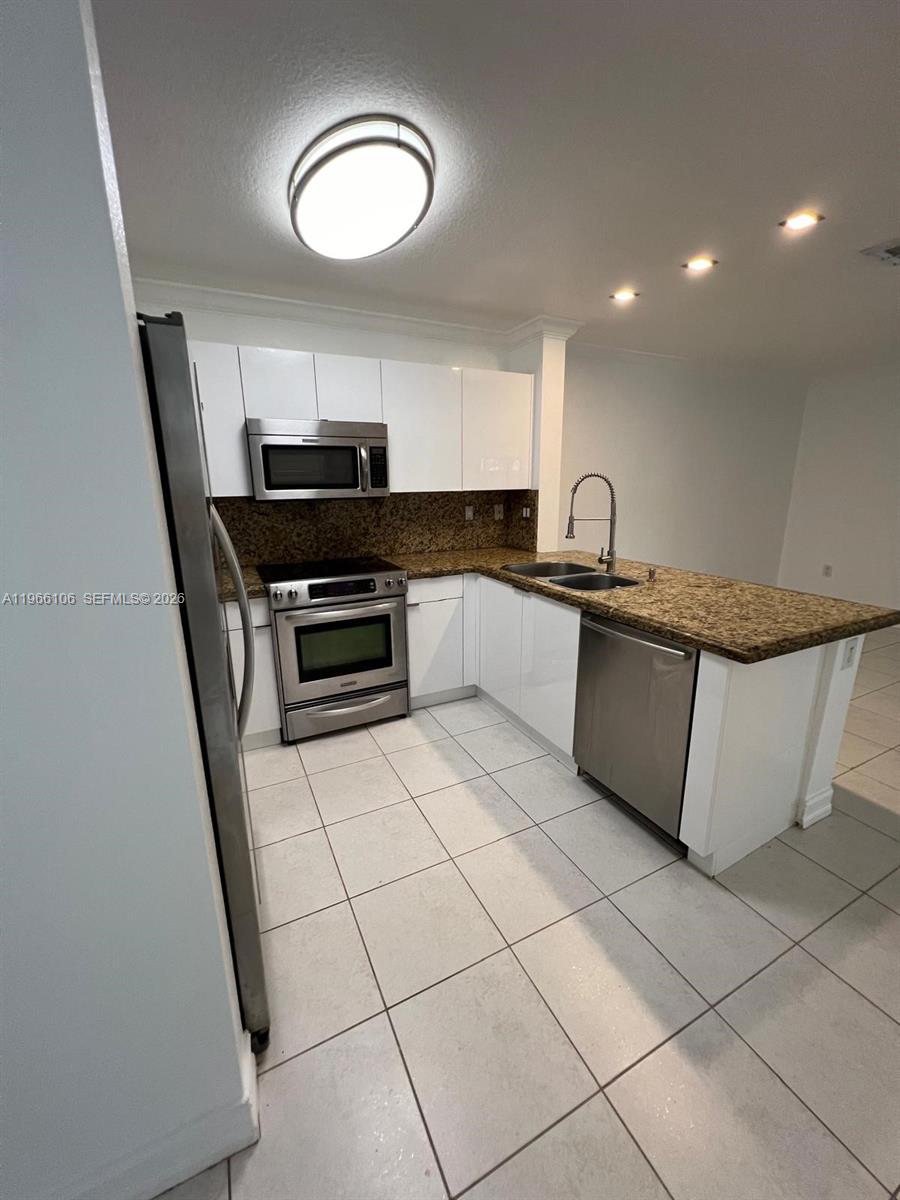 11320 Southwest 245th Street Homestead, FL 33032 - Photo 8 of 21 a kitchen with stainless steel appliances granite countertop a sink and a stove