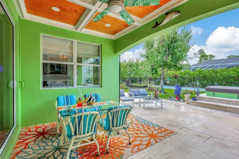 a view of a house with backyard porch and sitting area