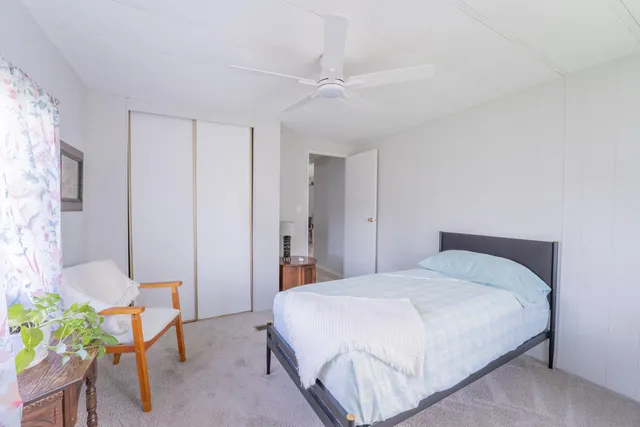 a bedroom with a bed and a table