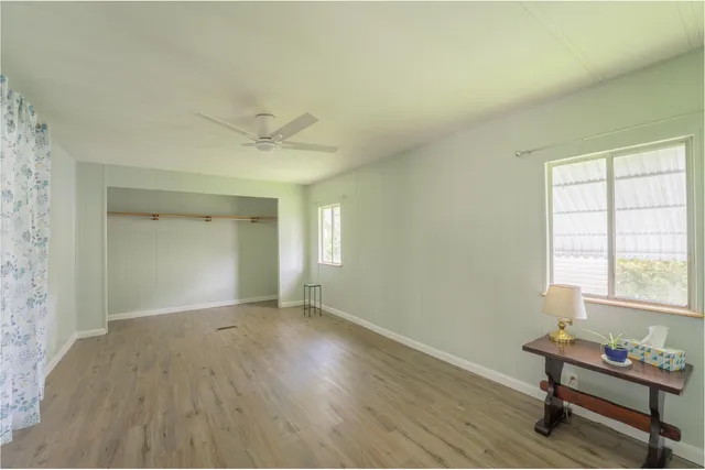 a view of a workspace with wooden floor and a window