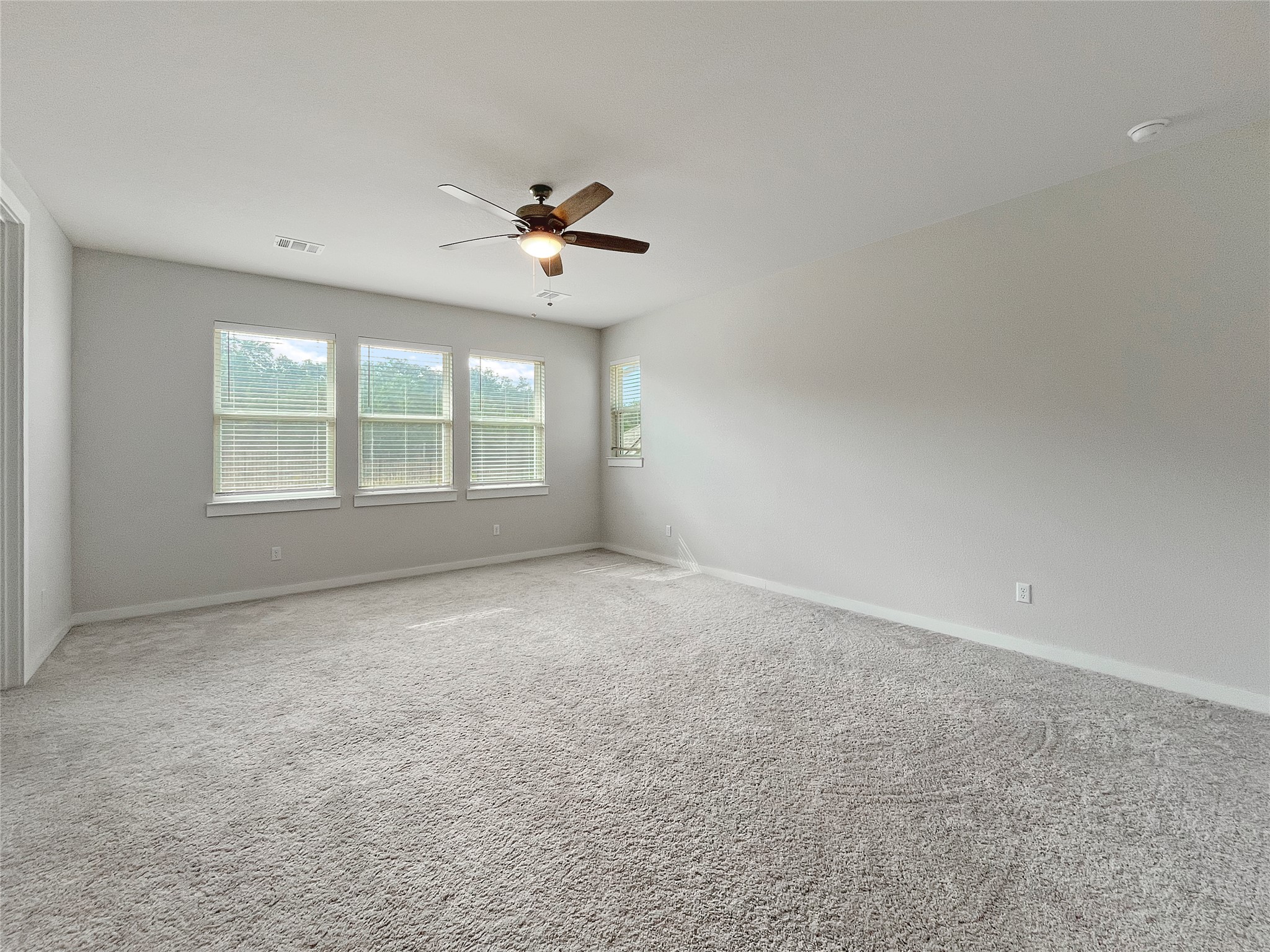 1200 Willie Rnch Way Leander, TX 78641 - Photo 13 of 25 Carpeted empty room featuring baseboards and ceiling fan