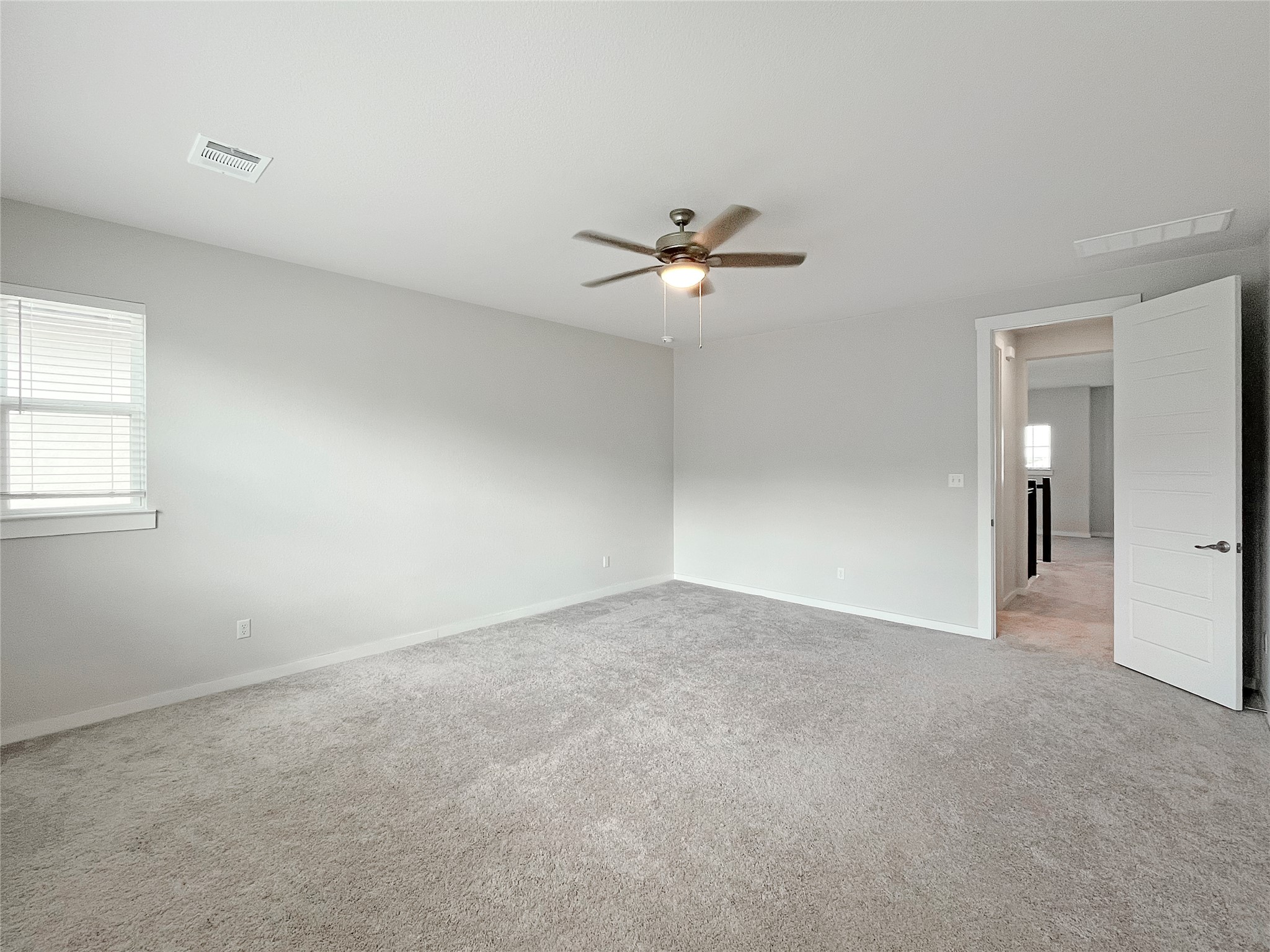 1200 Willie Rnch Way Leander, TX 78641 - Photo 14 of 25 Empty room with light carpet and a ceiling fan