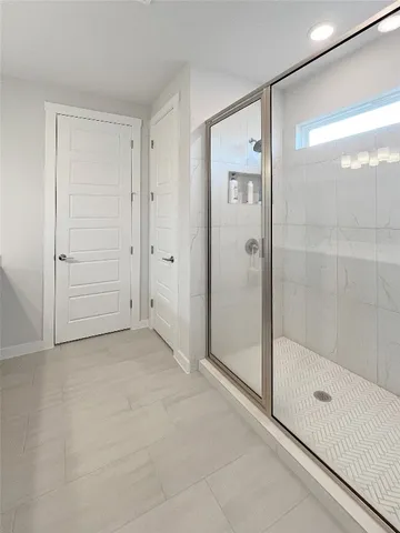 a spacious bathroom with a double vanity sink a mirror and a