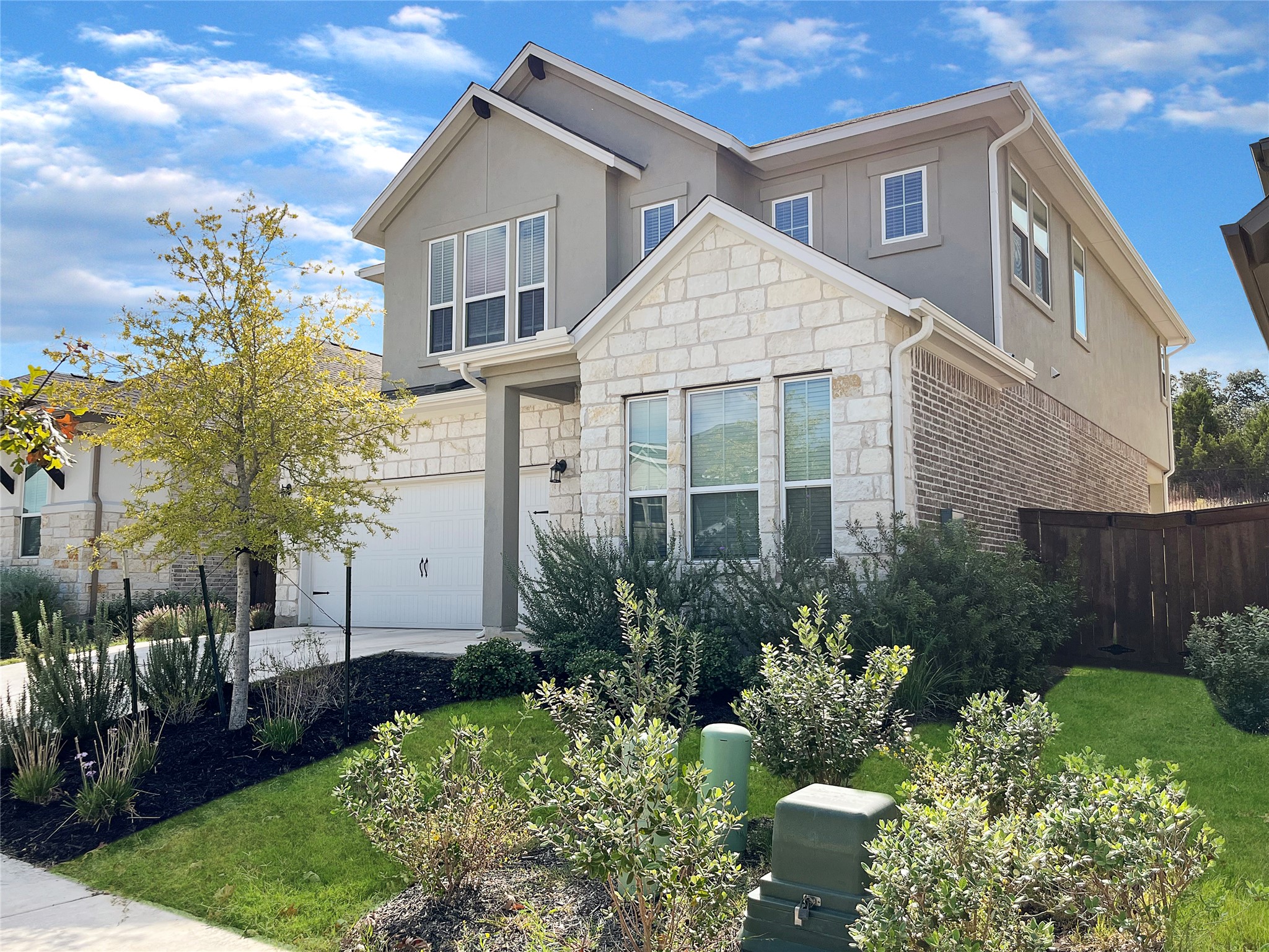 1200 Willie Rnch Way Leander, TX 78641 - Photo 21 of 25 View of front facade with stone siding, stucco siding, and an attached garage