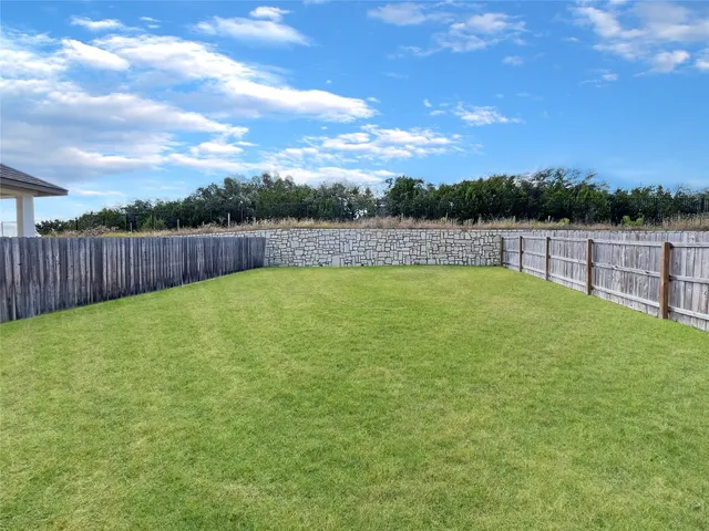 a view of a backyard with a lake view