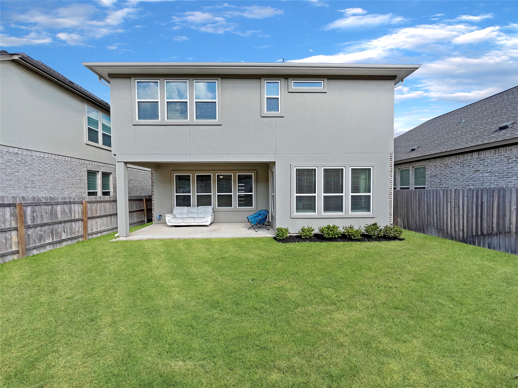 1200 Willie Rnch Way Leander, TX 78641 - Photo 24 of 25 Back of house with a fenced backyard, a patio, and stucco siding